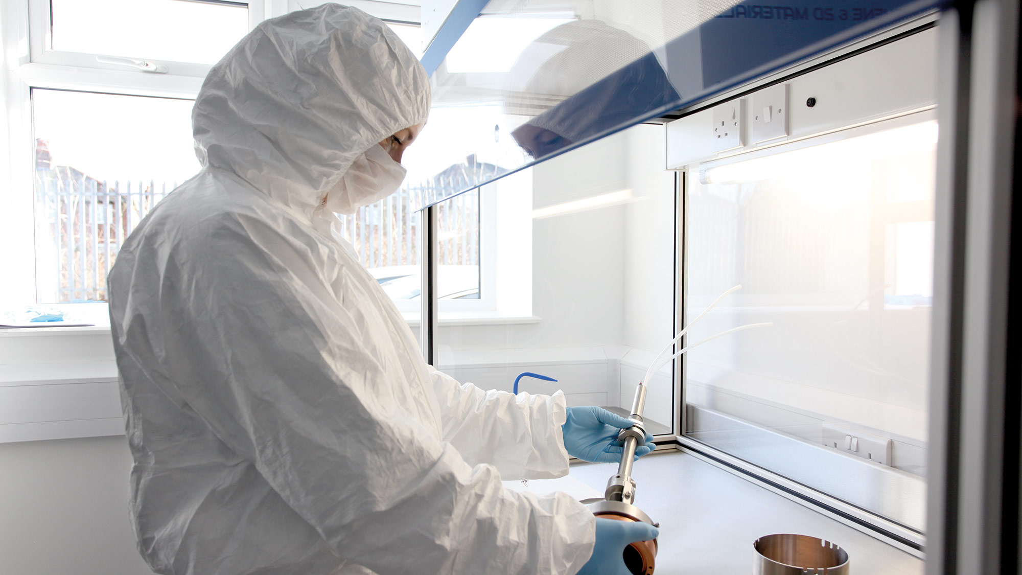 Photo of a person wearing a clean hood in a laboratory environment - Integrity Cleanroom